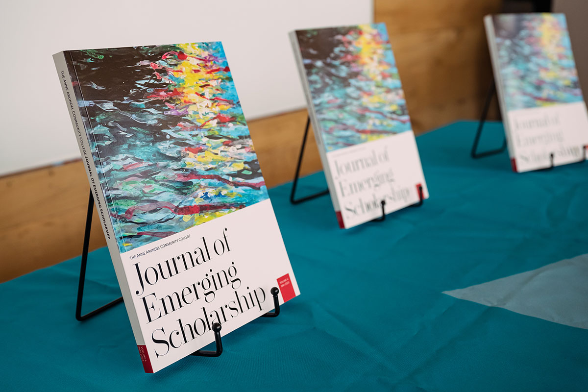 Two Journal of Emerging Scholarship propped up on a table.