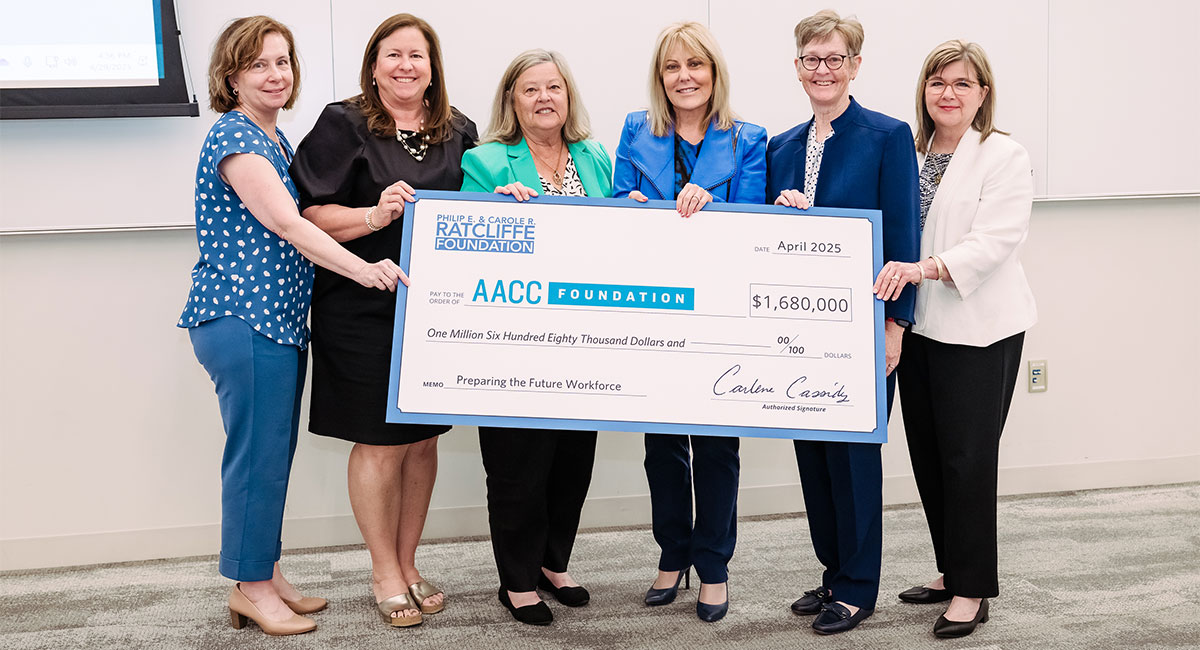 College administrators holding a large check for the AACC Foundation for $1,680,000