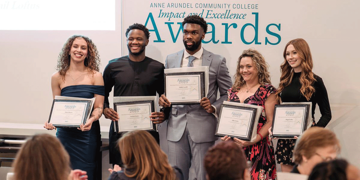 Students pose with their award certificates at ceremony.
