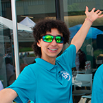 Minerva Stephensbailey wearing a teal AACC shirt and sunglasses/