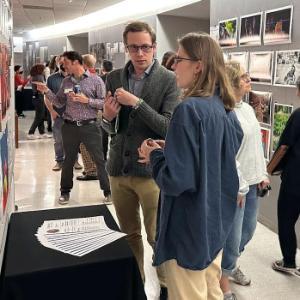 Student engaging with representative about their artwork