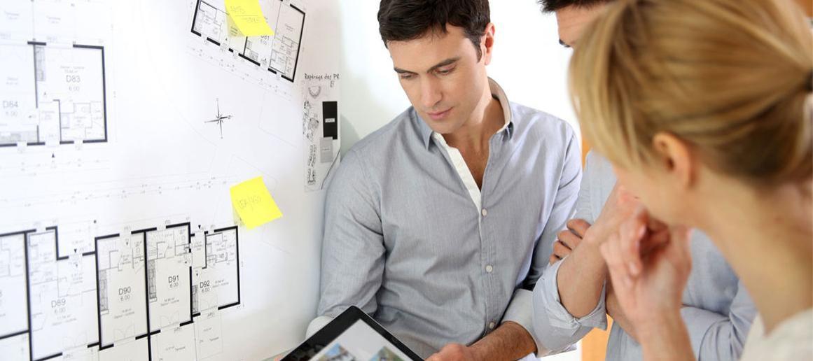 Architecture student discussing blueprint.