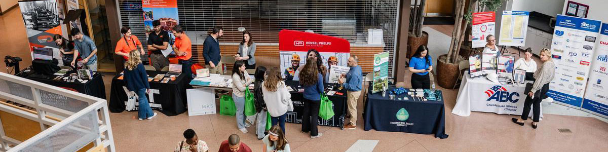 Students chatting with representatives from various trades companies in the community.