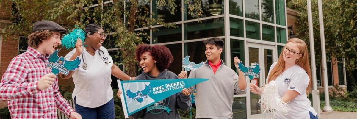 Five students outside of Student Services building with AACC apparel.